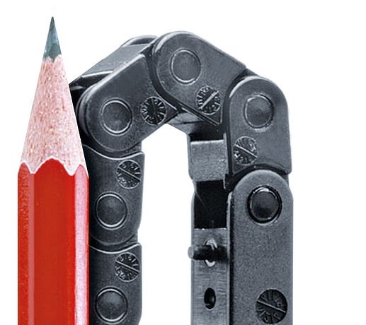 An E2 micro cable carrier next to a pencil for scale