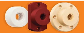 Three trapezoidal lead screw nuts lined up from left to right: the first is a white cylindrical nut with counterclockwise grooves spiraling inward. The second is a dark maroon nut with a tall rectangular backing featuring three holes: a small hole at the top and bottom, and a larger hole with counterclockwise grooves. The third is a light tan nut with a thin cylindrical backing, featuring six evenly spaced small holes around its face, and a large hole with counterclockwise grooves spiraling to the back.