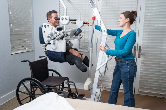 The UpLyft being used to transfer a patient from bed to wheelchair