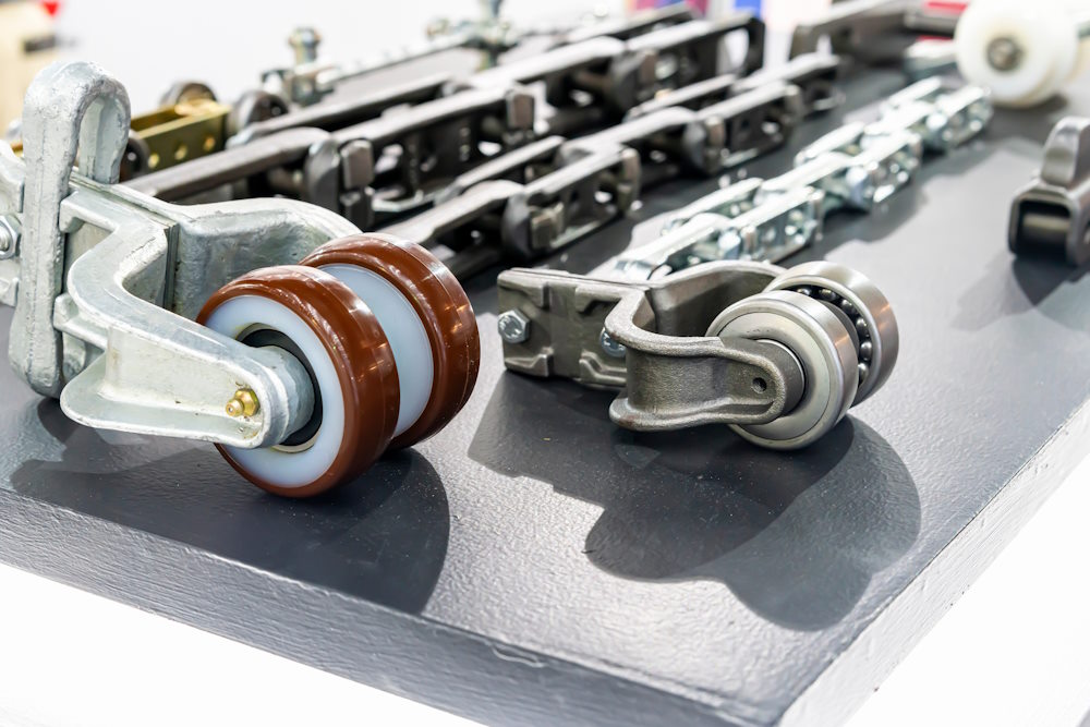 The chains and rollers used in an overhead conveyor system